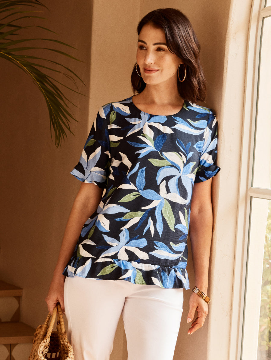 Woman wearing a blue floral patterned top in a home setting