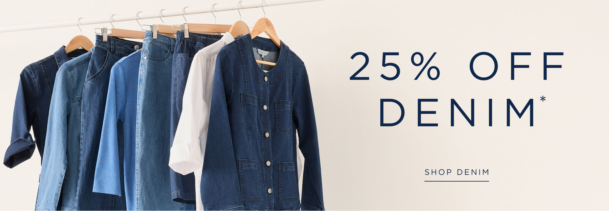 Denim jackets hanging on a rack with a promotional message for 25% off denim.