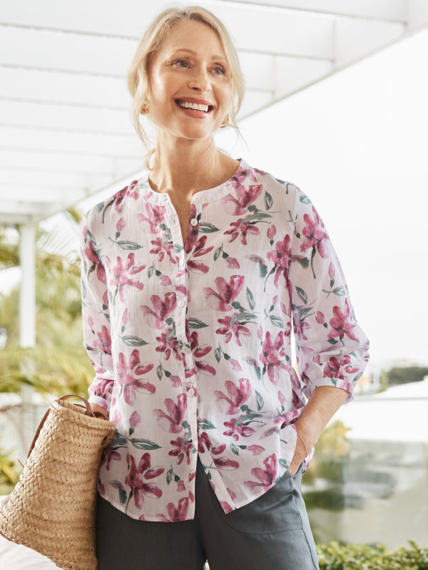 Woman wearing a floral shirt outdoors with a blurred background