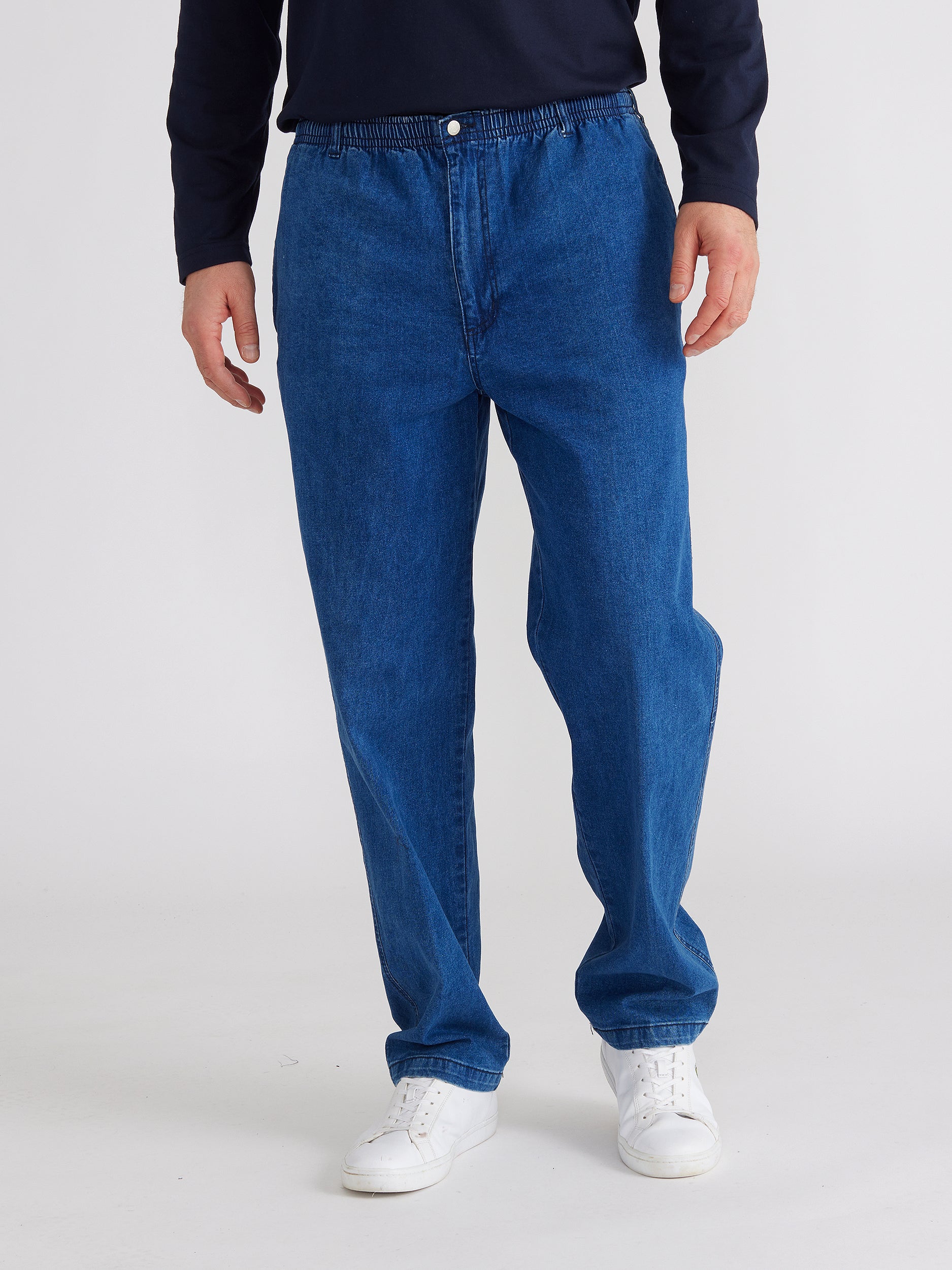 front image of model wearing mens ipswich denim jean in denim blue colour. The jean has elastic waist and button with fly.